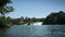 Waterfall of Rhine river with massive water power and ships with tourists