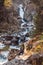waterfall on the river in late autumn in mountains. Early morning in late autumn in the mountains. Pure mountain river