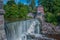 Waterfall of a river near a hydroelectric dam in Finland during a sunny day.