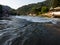 Waterfall on the river Vrbas in Novoselija, near Banja Luka. Landscape with river, village and forested mountains during a sunny