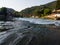 Waterfall on the river Vrbas in Novoselija, near Banja Luka. Landscape with river, village and forested mountains during a sunny