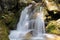 waterfall between rocks in the mountain