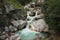 Waterfall among the rocks in mountain forest