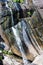 Waterfall in rocky mountains in rainforest on tropical island