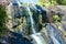 Waterfall in rocky mountains in rainforest on tropical island Langkawi in Asia