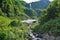 A waterfall rushes down from the edge of the mountain.