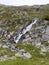 Waterfall at Schlegeisspeicher reservoir at Berlin high path, Zillertal Alps in Tyrol, Austria