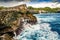 Waterfall into the sea. Waves splashing against a cliff. Blue water. Angel billabong, Nusa Penida, Bali