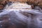 Waterfall in several stages and fallen leaves