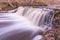 Waterfall in several stages and fallen leaves