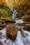 Waterfall Shipot in the autumn forest of the Carpathian Mountains