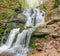 Waterfall Shypit in beech forest in Carpathian mountains in spring
