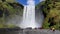 Waterfall Skogafoss under bright blue sky, Iceland