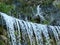 Waterfall in slow motion and blur. rocks and green plants behind. summer nature scene.