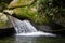 Waterfall Splashes Flowing From The Rocks. Jungle  Mountain River, Stones And Liana.