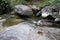 Waterfall with stone of green moss in rain forest , Kiriwong Vil