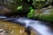 Waterfall with stone of green moss in rain forest , Kiriwong Vil