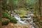 Waterfall and stones covered in moss at Nakasendo walking trail