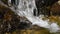 Waterfall stream of rapid water over rocky stones