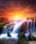 Waterfall on sunset background