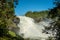 The waterfall Tannforsen in northern Sweden with a rainbows in the water spray