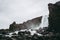 The waterfall in Thingvellir National Park, Iceland flowing from the river Ã–xarÃ¡ into the pool filled with rocks