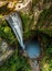 Waterfall tumbling over the sheer cliffs to idyllic waterhole