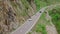 Waterfall, tunnel, Susten Mountain Pass road, Canton of Bern, Switzerland 08.16.2023: Crane Rolling Shot of a Porsche