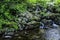 Waterfall in two streams with big stones near the water