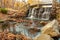 Waterfall under rustic foot bridge