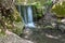 Waterfall in the valley of butterflies Petaloudes on Rhodes island, Greece