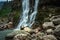 Waterfall white water stream falling from mountains at day from flat angle