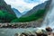 Waterfall white water stream falling from mountains with valley at day long exposure