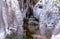 Waterfall in winter. Water jets freeze and icicles form. Attractive ice shapes and white frost - like a theater stage