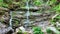 Waterfalls forest virgin nature Vysoky vodopad, aerial drone stream way through stones fairytale summer landscape