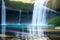 Waterfalls with rainbows Incorporate a reflective surface made with generative ai