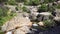 Waterfalls of a river descending on several levels between the rocks of the high mountain.