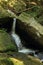 Waterfalls of saint Wolfgang among green rocks