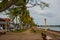 Waterfront with beautiful trees in cloudy weather. Dumaguete, Philippines