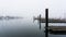 Waterfront and boating dock on a misty morning