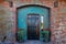 Waterfront Clam Cannery Brick Building entryway includes old wooden door and oxidized green