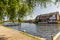 Waterfront holiday properties on the bank of the River Bure in the village of Hoveton and Wroxham, Norfolk, UK