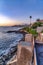 Waterfront homes at San Diego California rocky coast with ocean and sunset view