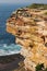 Waterfront lookout on hill with idyllic and amazing seaside landscape of sheer cliff with shrubs and beach below