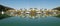 Waterfront maritime resort marina/dock with boats clear water reflections. Commercial image