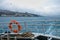 Waterfront overboard from the sea. Lifebuoy in the foreground.