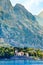 Waterfront of small town Dobrota along Bay of Kotor, Montenegro. View of Church of St Mathew, coastal villas, mountains and quay.