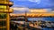 Waterfront Sunset in Seattle with Ferris Wheel, Cranes, & Boats