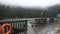 Waterfront wooden bridge and Motion of water of Mummelsee lake while raining