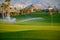 Watering of evergreen grass field on large golf course on Tenerife island, Canary, Spain